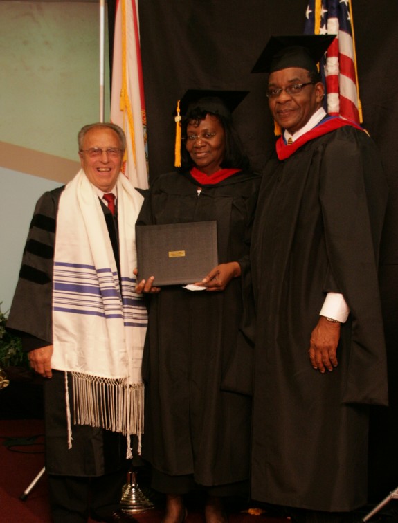 Dr. Nelson and Pastor Stewart confer degrees.