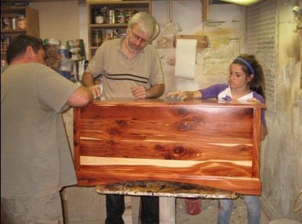 Andy Bell and his daughter Natalie and Lowell Regehr constructing her Hope Chest